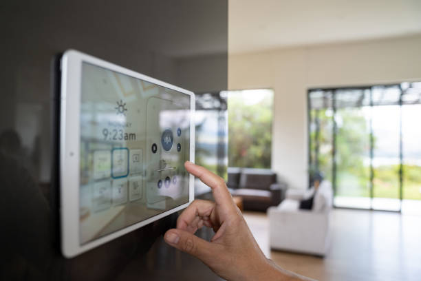 Close-up on a person using a home automation system to control the music - smart homes concepts